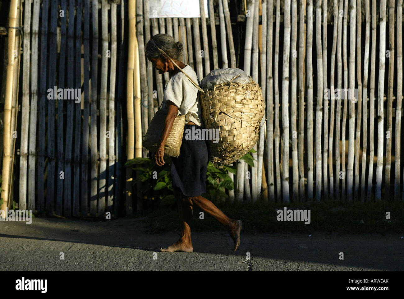 Mangyan woman carries basket goods hires stock photography and images