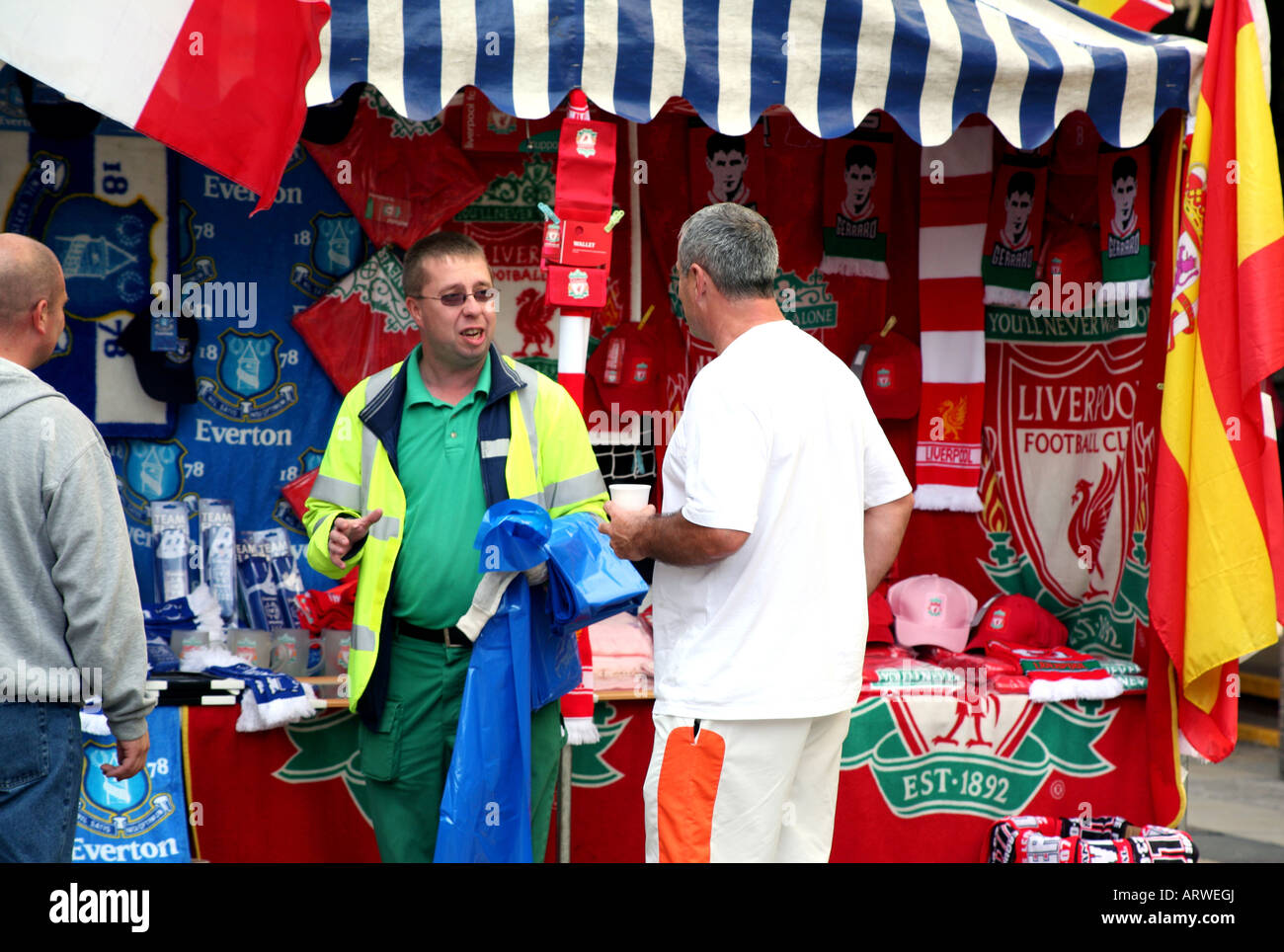 Traders sell Liverpool FC and Everton FC memorabilia off stall in Liverpool city centre Stock Photo