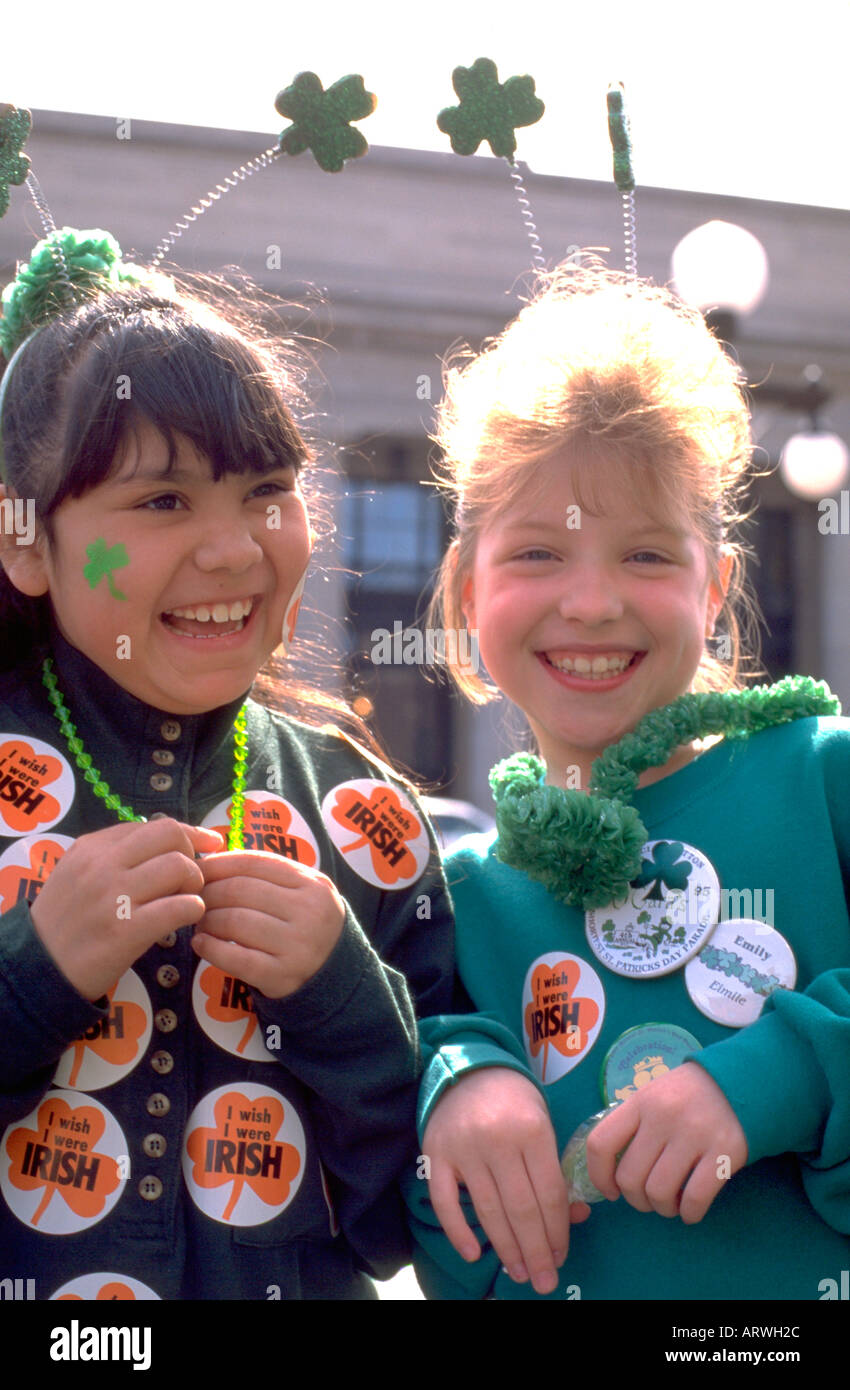 Friends age 8 dressed up in clover buttons for St Patrick's day celebration. St Paul Minnesota USA Stock Photo