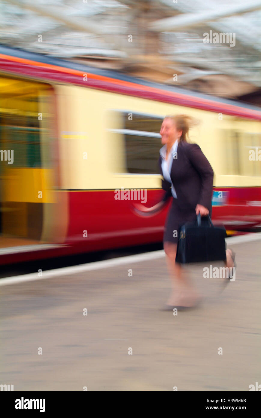 Business woman running on train platform Stock Photo - Alamy