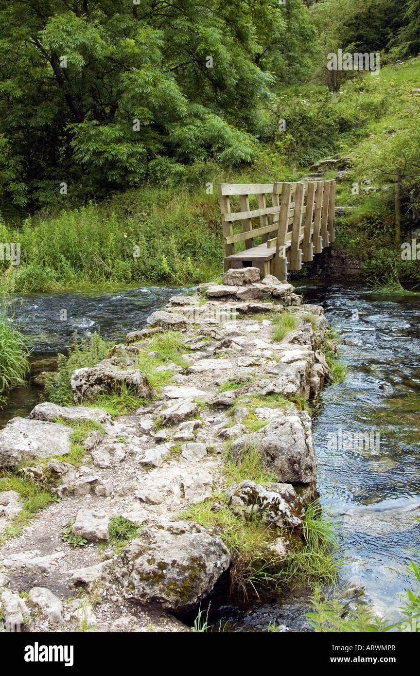 Rocky path leading to wooden bridge over a stream Stock Photo - Alamy