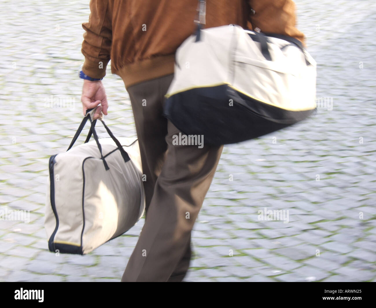 detail of man carrying two bags Stock Photo - Alamy