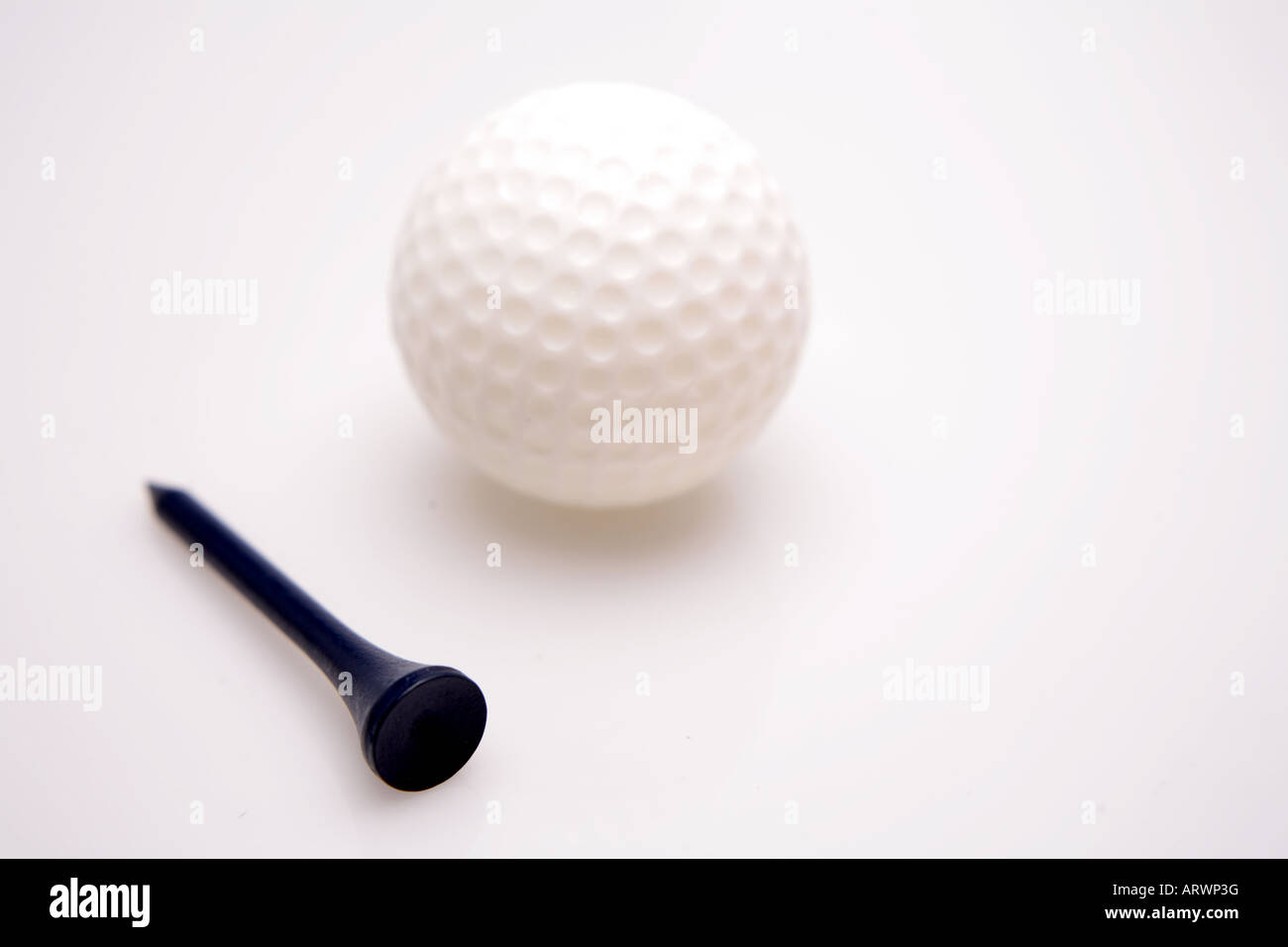 Golf ball and tee over white Stock Photo Alamy
