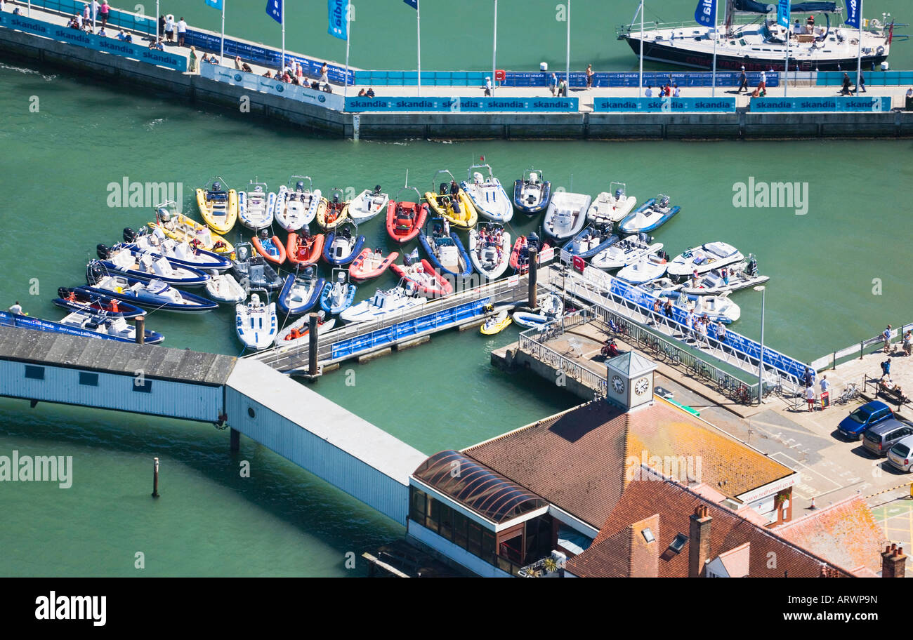 RHIBs (Rigid Hull Inflatable Boats) moored at Cowes quay while sailors go ashore during Skandia Cowes Week. Stock Photo