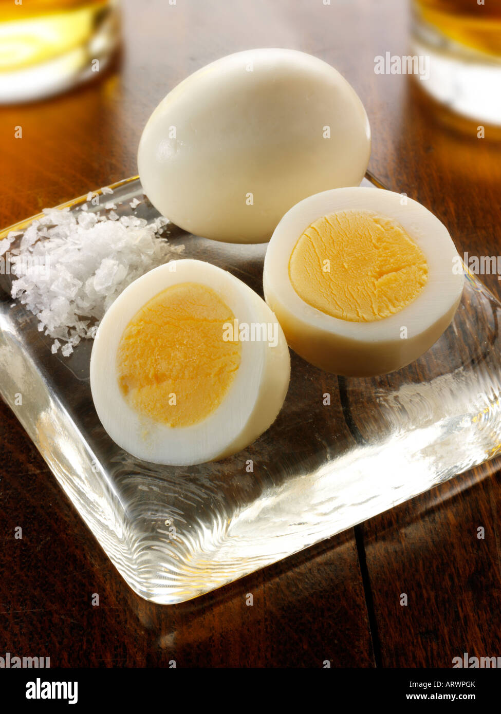 Traditional British preserved pickled eggs pub food on a traditional  wood pub table ready to eat Stock Photo