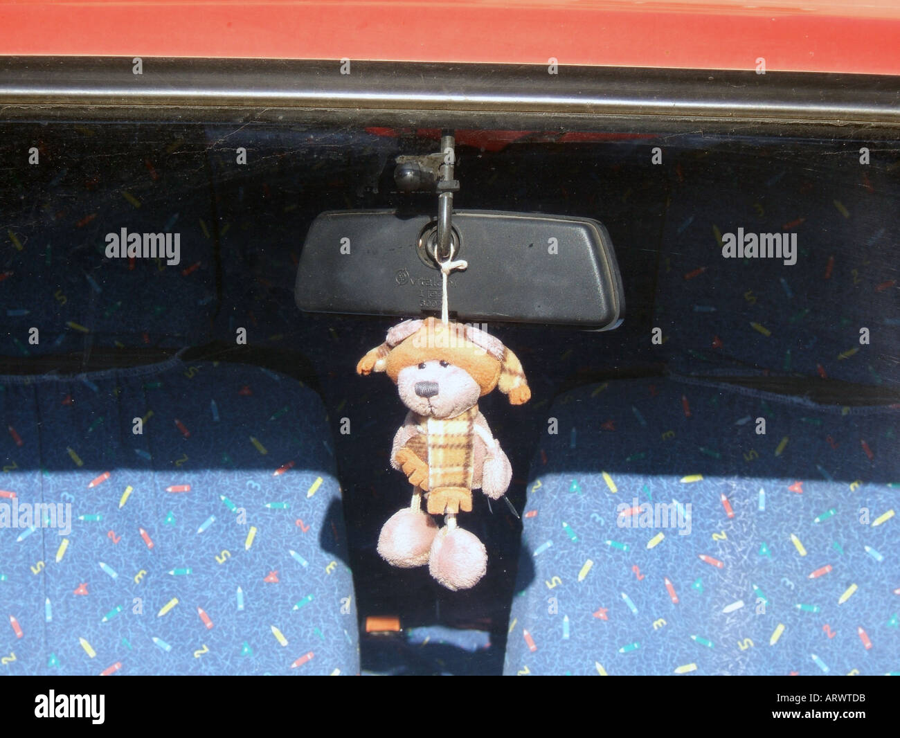 teddy bear hanging from car