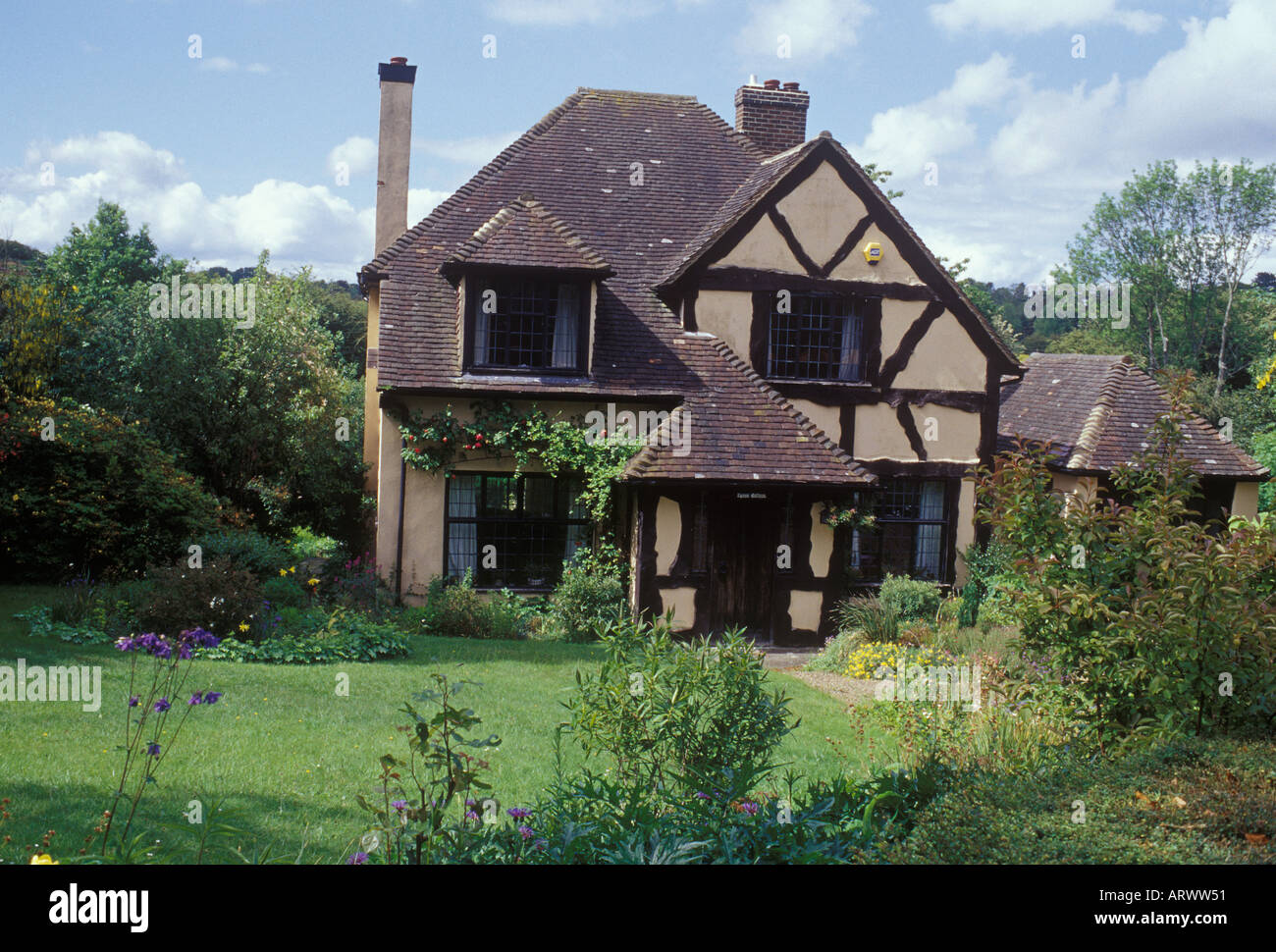 Kingswood, Surrey, England  Pre 1930 mock Tudor style half timbered cottage with garage set in lush garden Stock Photo