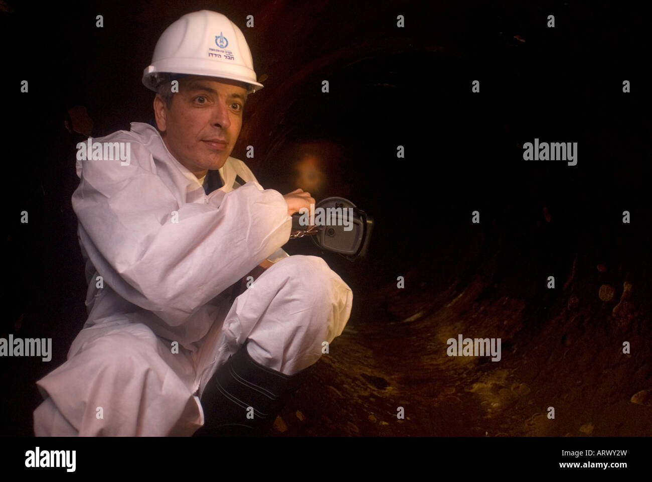 An Israeli worker inside a large diameter pipeline of Mekorot the National Water Company of Israel known as the National Water Carrier Stock Photo