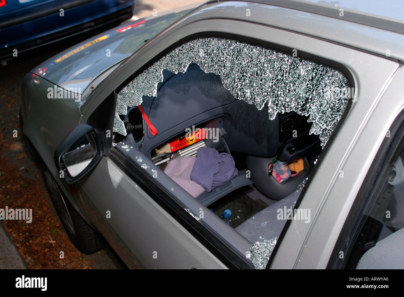 UK motoring crime theft car with broken in passenger window Stock Photo