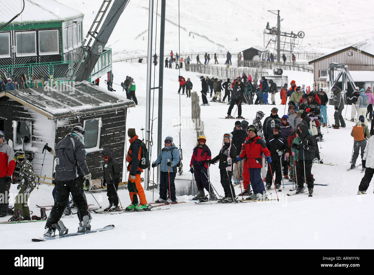 skiers and snowboarders wait to get on the chairlift at Glenshee ski centre near Braemar, Aberdeenshire, Scotland, UK Stock Photo