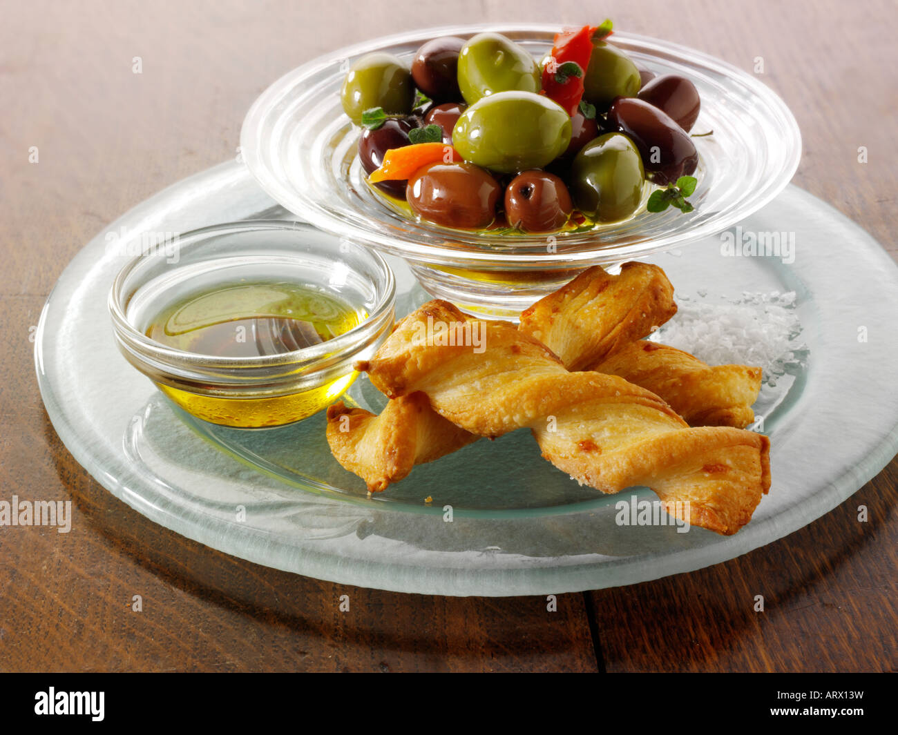 Olives with cheese straws and olive oil dip Stock Photo