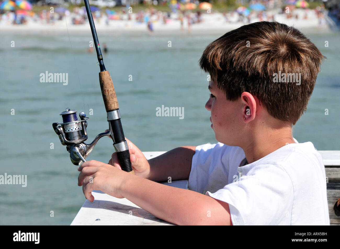 Twelve 12 year old boy fishing Stock Photo - Alamy