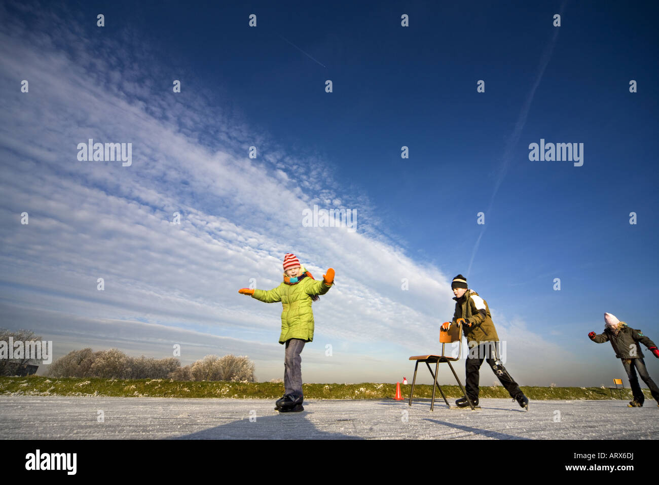 Winter in Holland. Kids learn to skate the traditional way: with a chair. Stock Photo