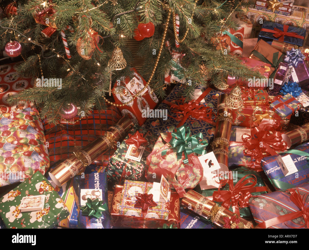 Christmas presents scattered around the base of a real Xmas tree in
