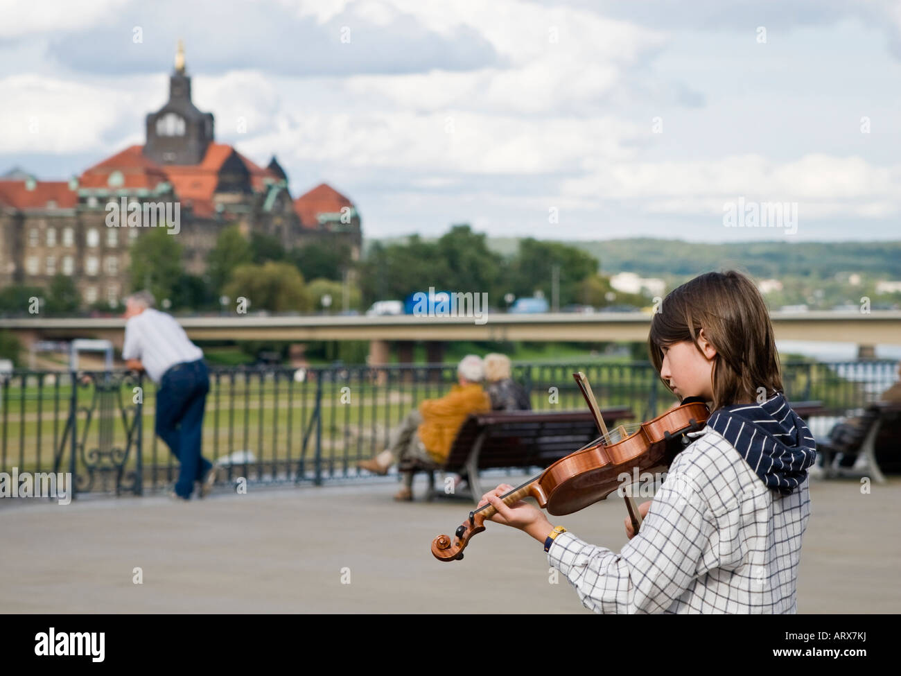 Teenage boy playing violin at Elbe river bank Dresden Germany Stock Photo