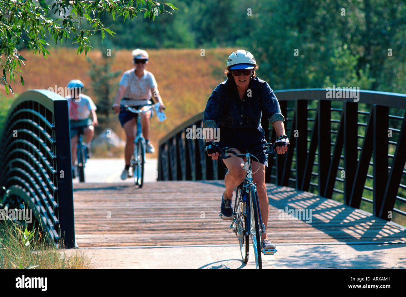Cyclists on pedestrian bridge Steamboat Springs CO USA Stock Photo