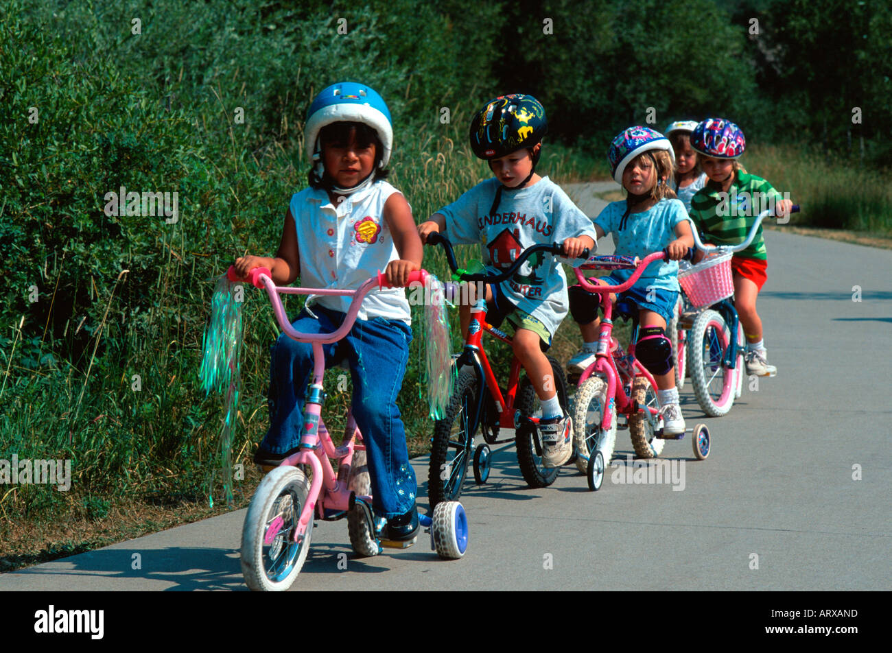 Group of young children cycling Steamboat Springs CO USA Stock Photo