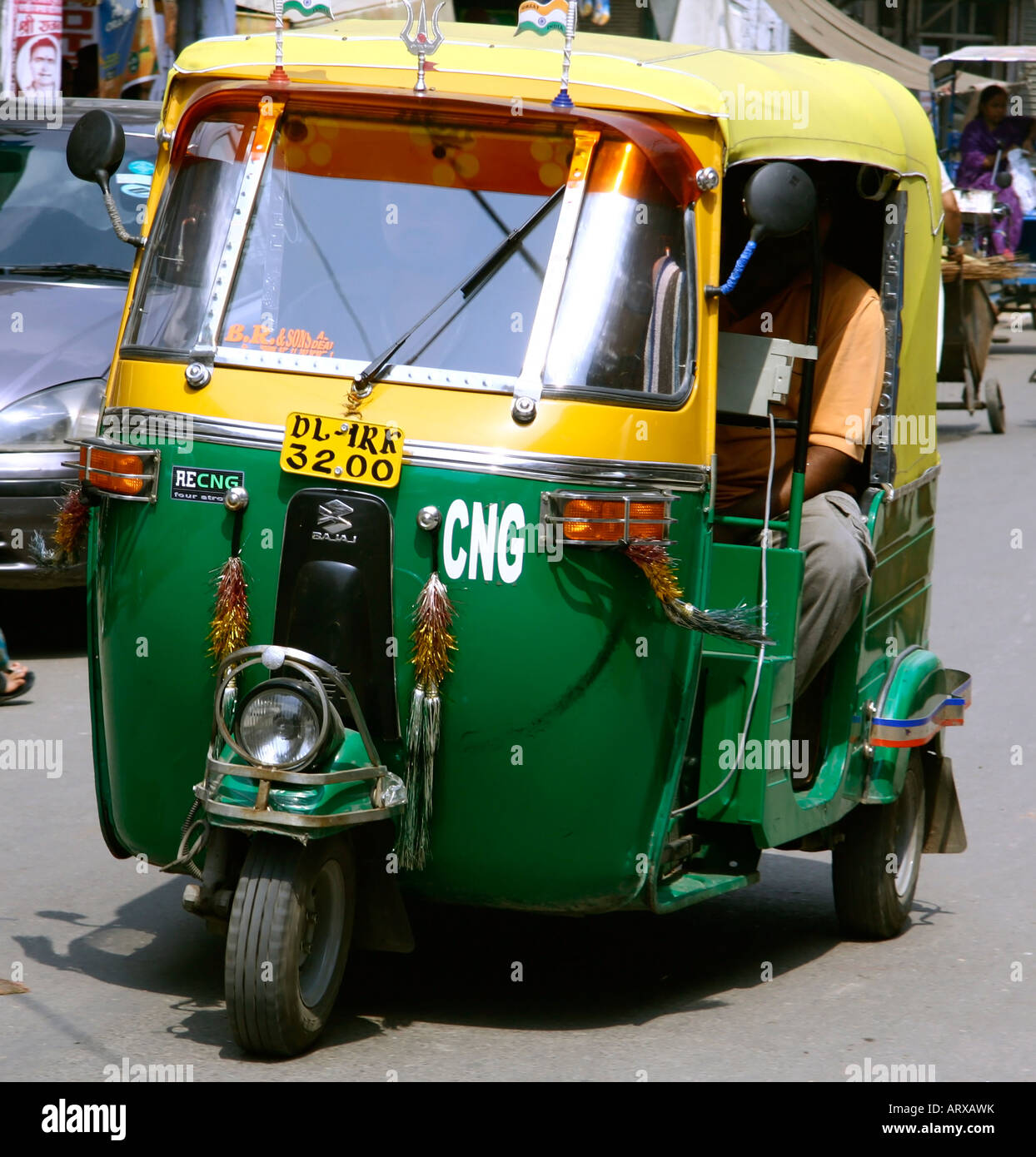 auto rickshaw driving on road delhi india Stock Photo - Alamy