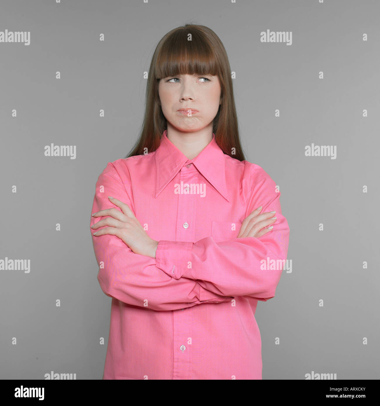 studio shot portraits of a expressive and funny red hair young woman with pink shirt get bored expression Stock Photo