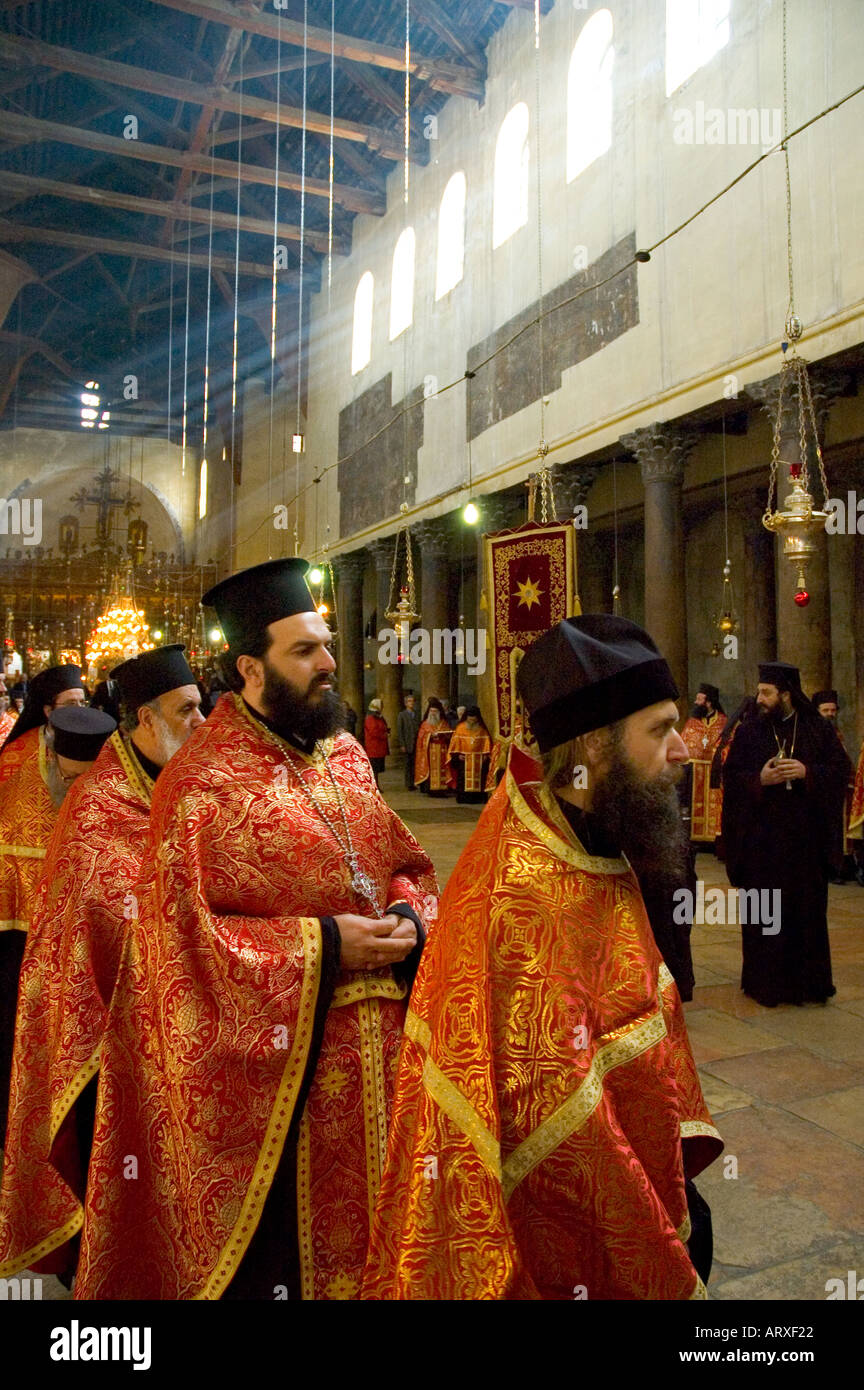 Palestinian Authority Bethlehem church of the Nativity Orthodox Xmas Procession ready to come out of the church row of priests wearing their religious dress Stock Photo