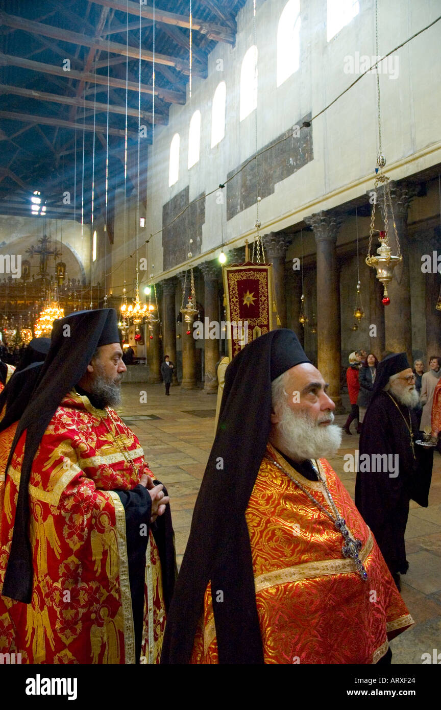 Palestinian Authority Bethlehem church of the Nativity Orthodox Xmas Procession ready to come out of the church priest looking upwards Stock Photo