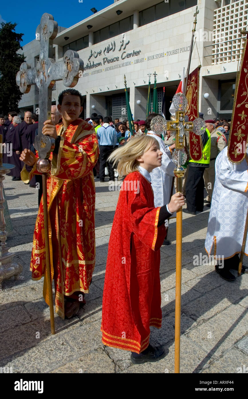 Palestinian Authority Bethlehem church of the Nativity Orthodox Xmas Procession outside the the church the 2 boys leading the procession vertical Stock Photo
