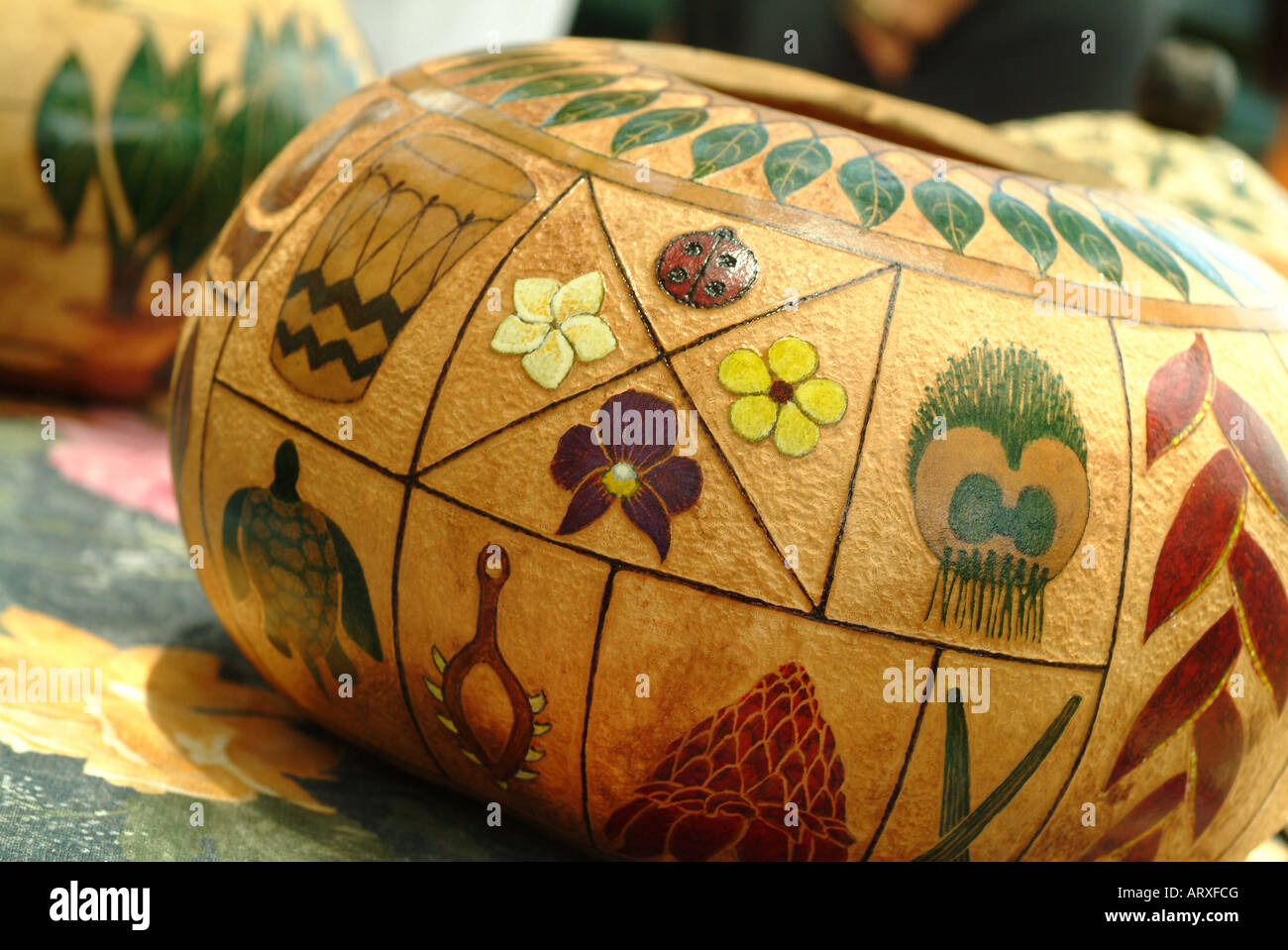 Gourd or bowl with intricate Hawaiian designs at a craft fair on Lei Day. Stock Photo