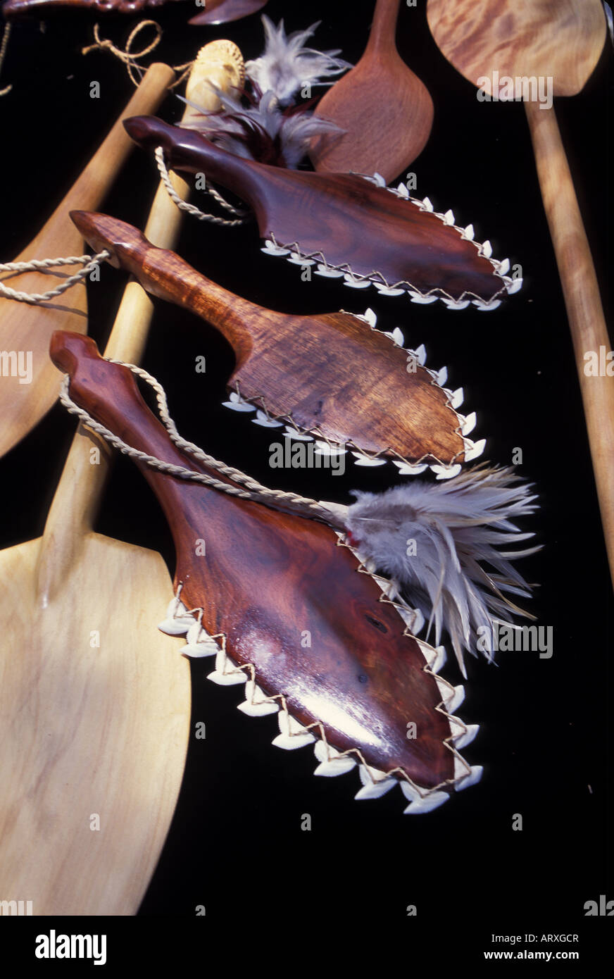 Canoe paddles, and war clubs ringed with tiger shark teeth, on display