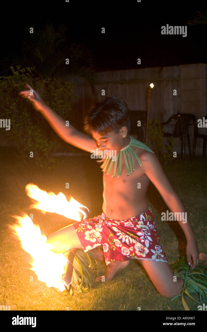 Young fire knife dancer spins his knives at a party in Laie Stock Photo -  Alamy