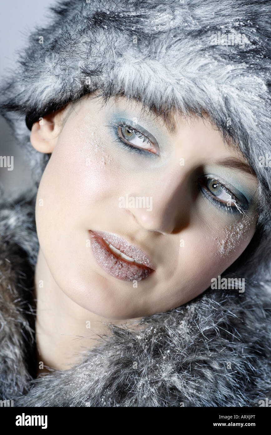 studio shot portrait of a beautiful woman russian type in a fur coat and hat Stock Photo