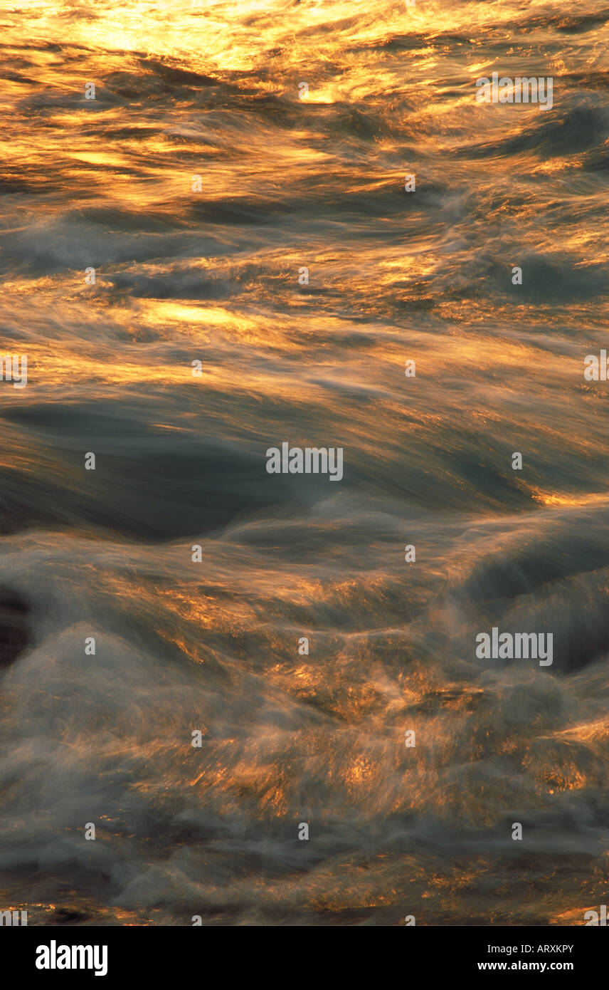 Ocean at sunset, slow shutter speed showing wave motion Stock Photo - Alamy