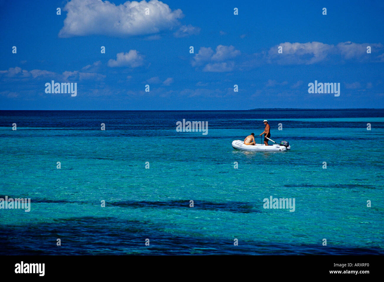Retirees on small boat in Caribbean ocean Stock Photo