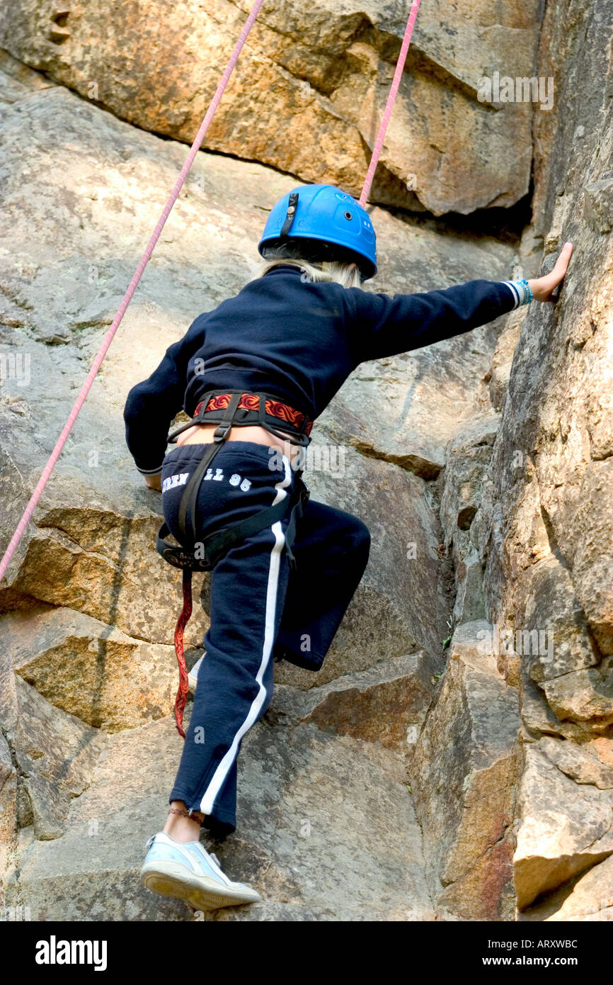 back of female little girl climbing a rock of mountain Stock Photo Alamy