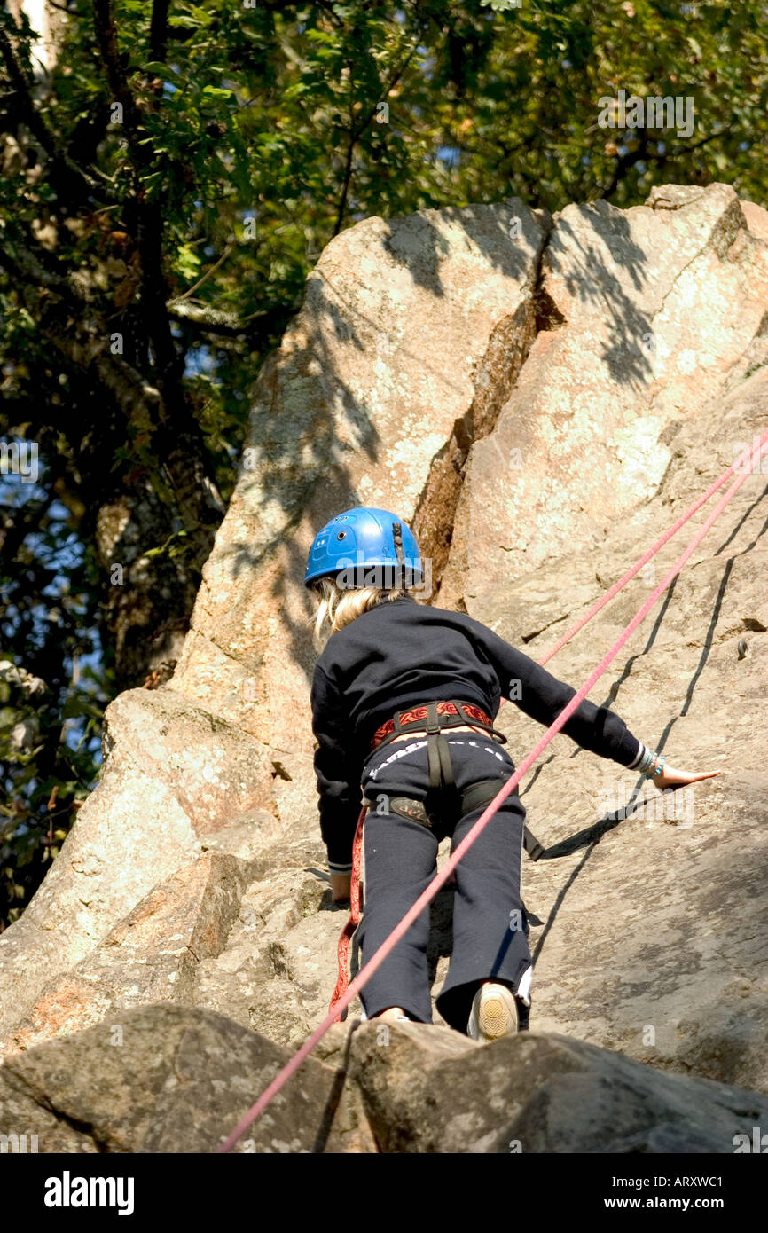 back of female little girl climbing a rock of mountain Stock Photo Alamy