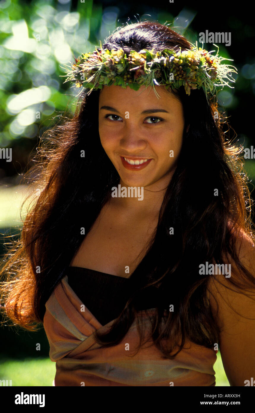 Young smiling Hawaiian hula dancer in a park in Honolulu on Oahu Stock Photo