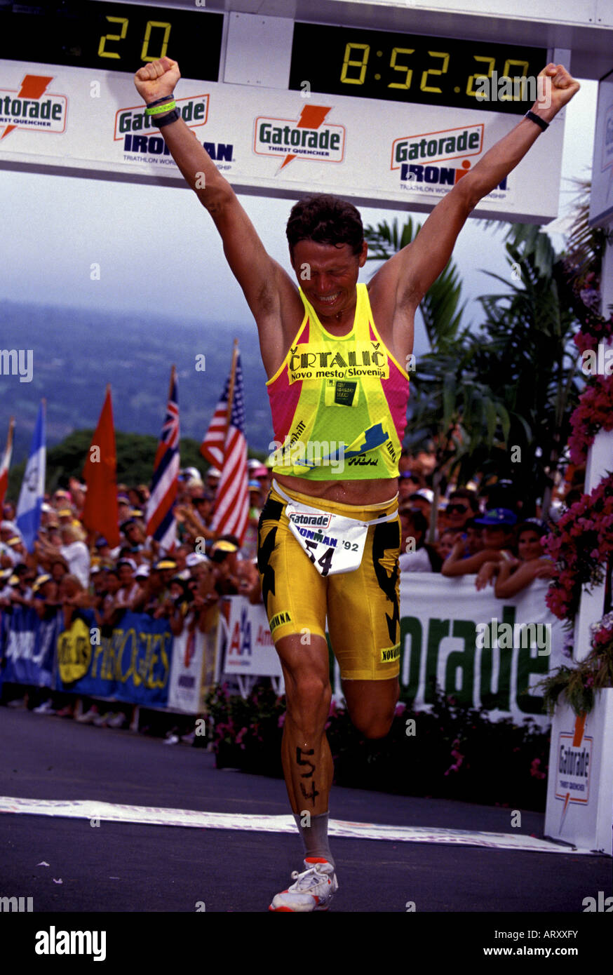 Spectators cheer the runners crossing the finish line of the world renowned  annual Ironman triathlon, at Kailua-Kona on the Big Stock Photo - Alamy, image size:874x1390