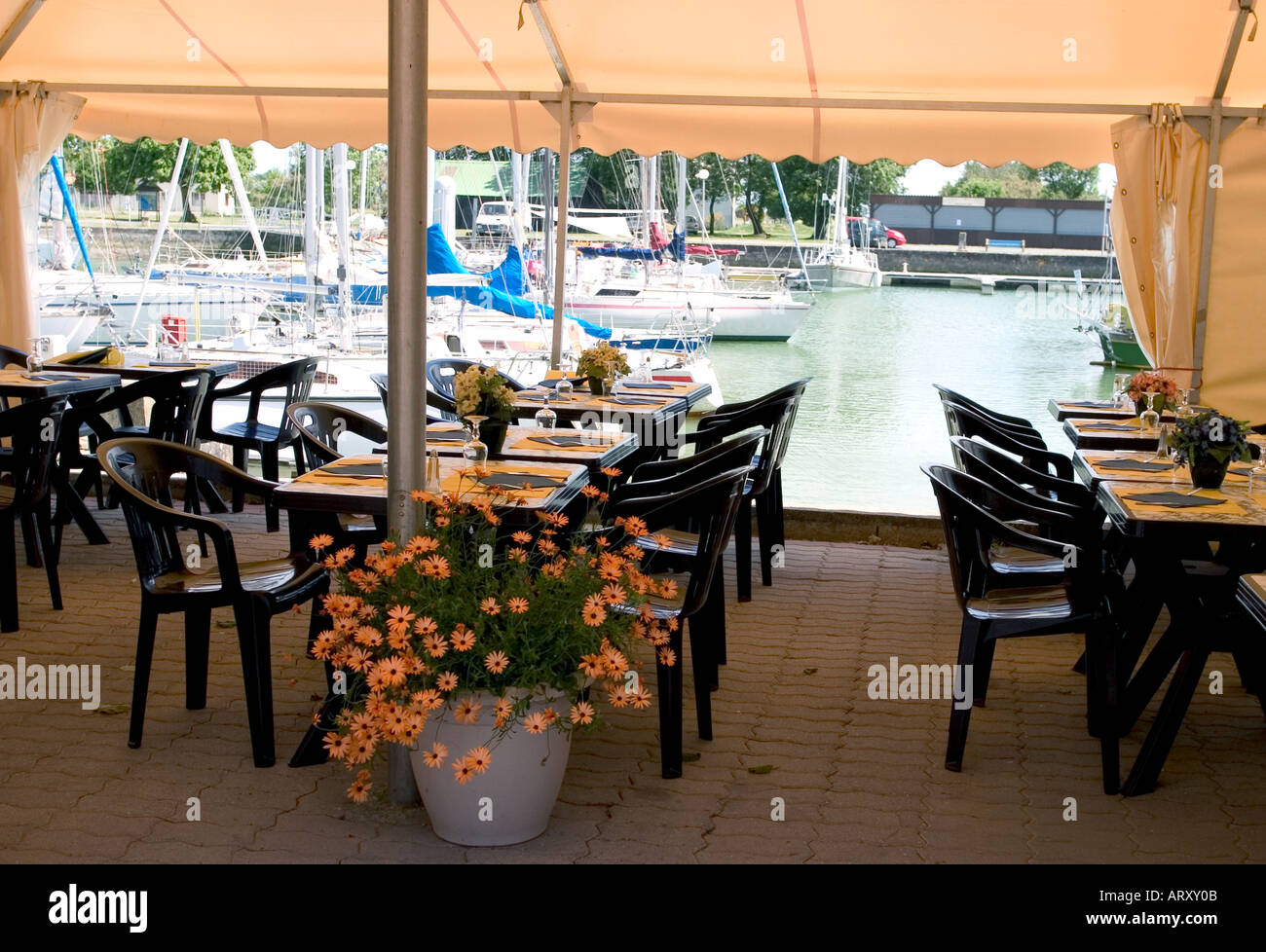 Terrace Of A Restaurant In France Near A Marina With Sailing Boat Stock Photo - Alamy