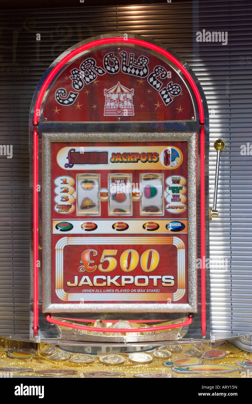 Jackpot machines in shop window Stock Photo Alamy