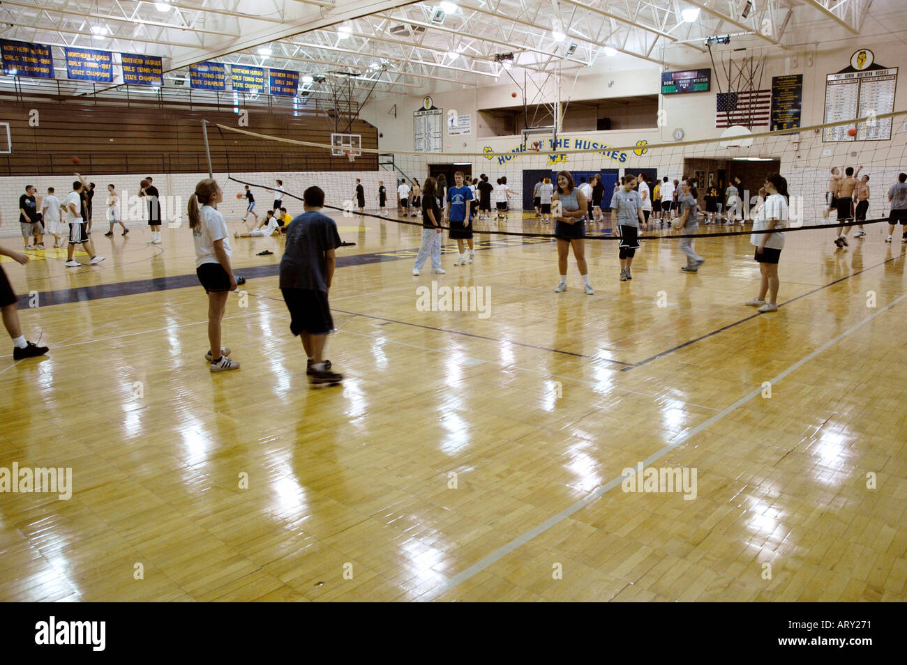 High school students play volleyball in a physical education class