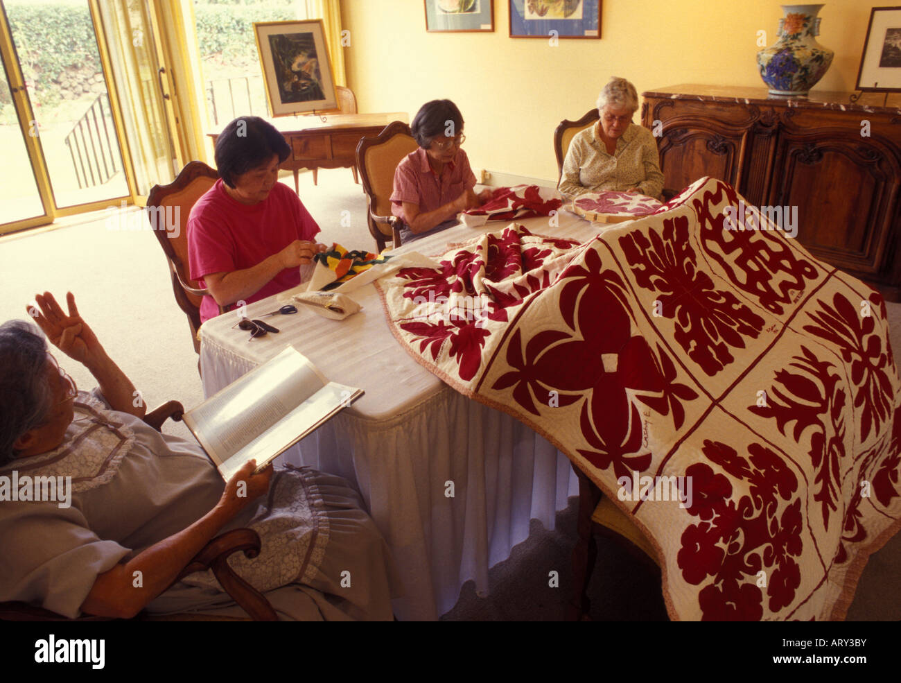 Women stitching Hawaiian quilts at Parker Ranch historical home on the Big island of Hawaii Stock Photo