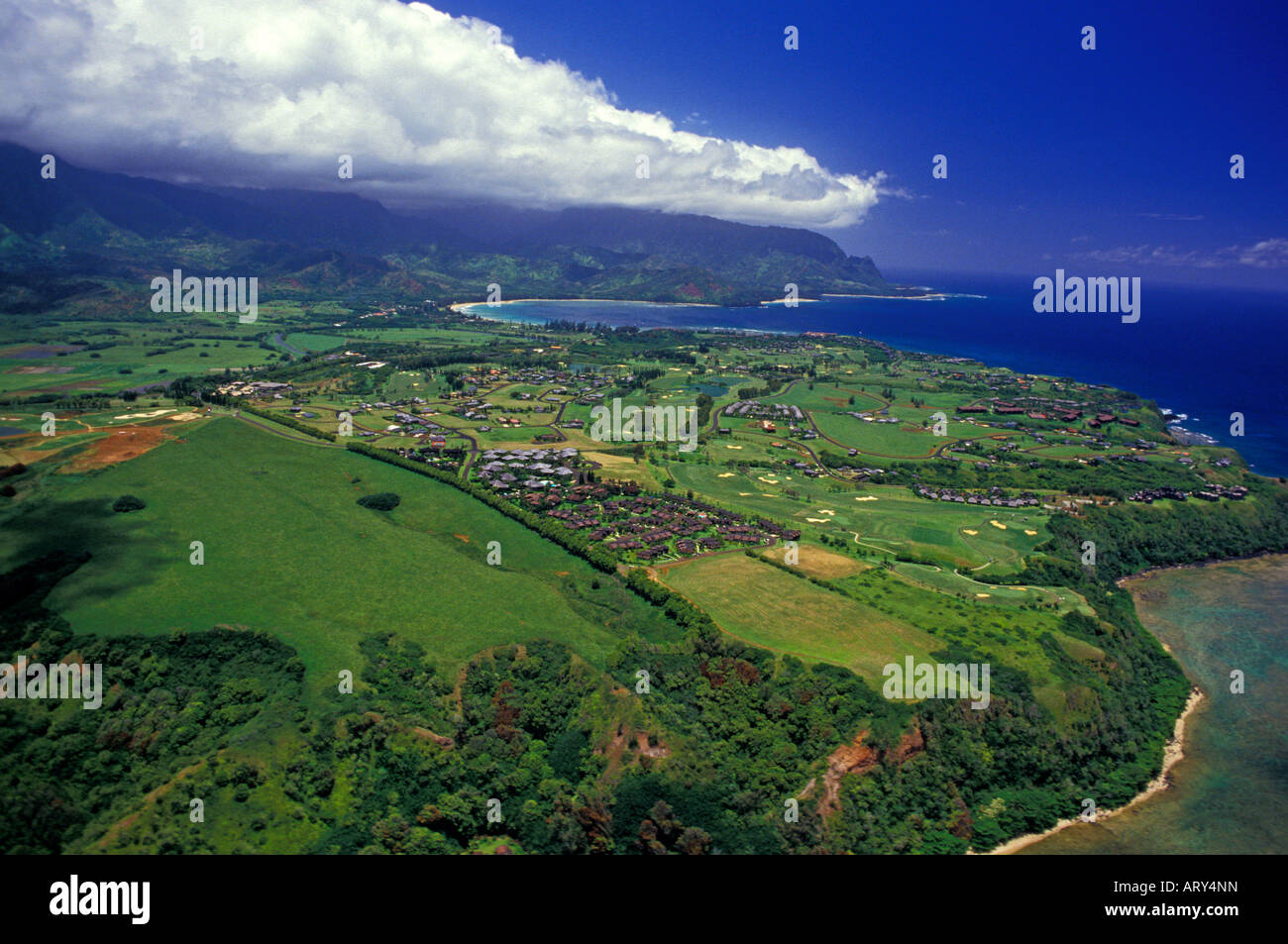 An aerial view of Princeville, Kauai, with a bank of clouds against the