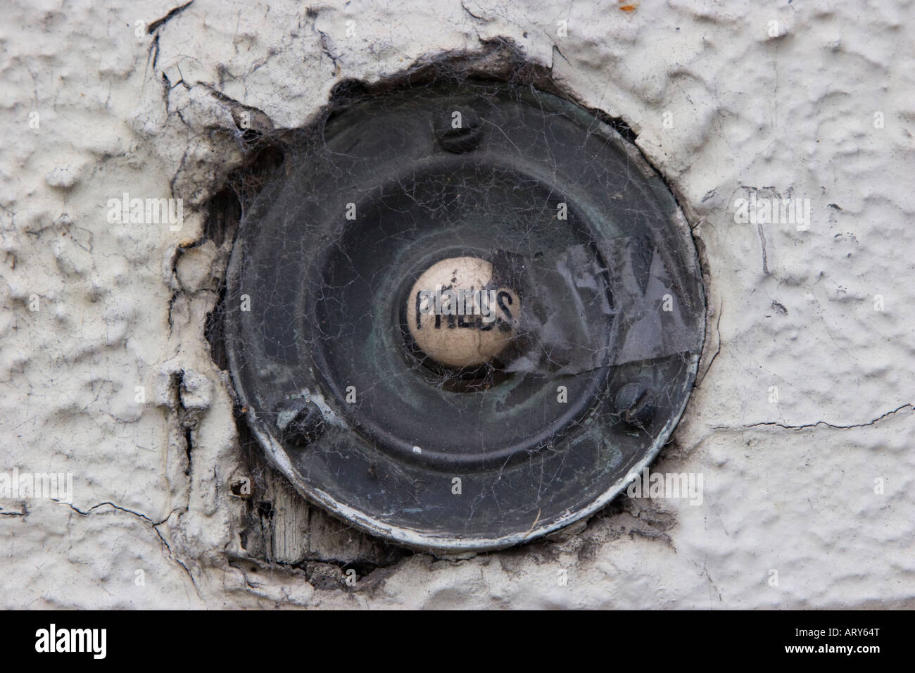 Old fashioned front door bell button which has seen better days Stock