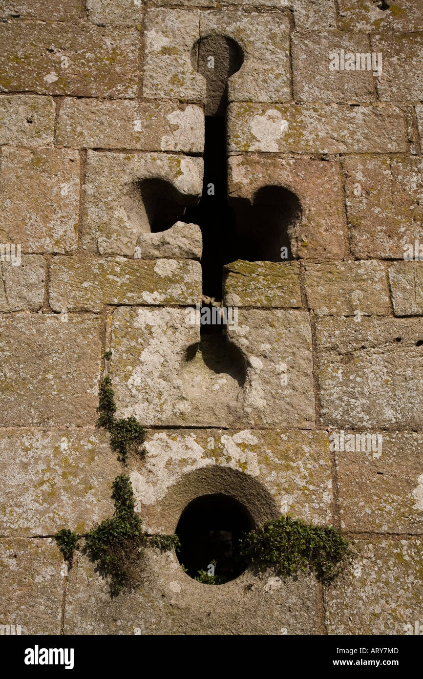 Arrow and gun ports in the Great Tower Raglan Castle indicating the transition period to gunpowder Monmouthshire Wales UK Stock Photo