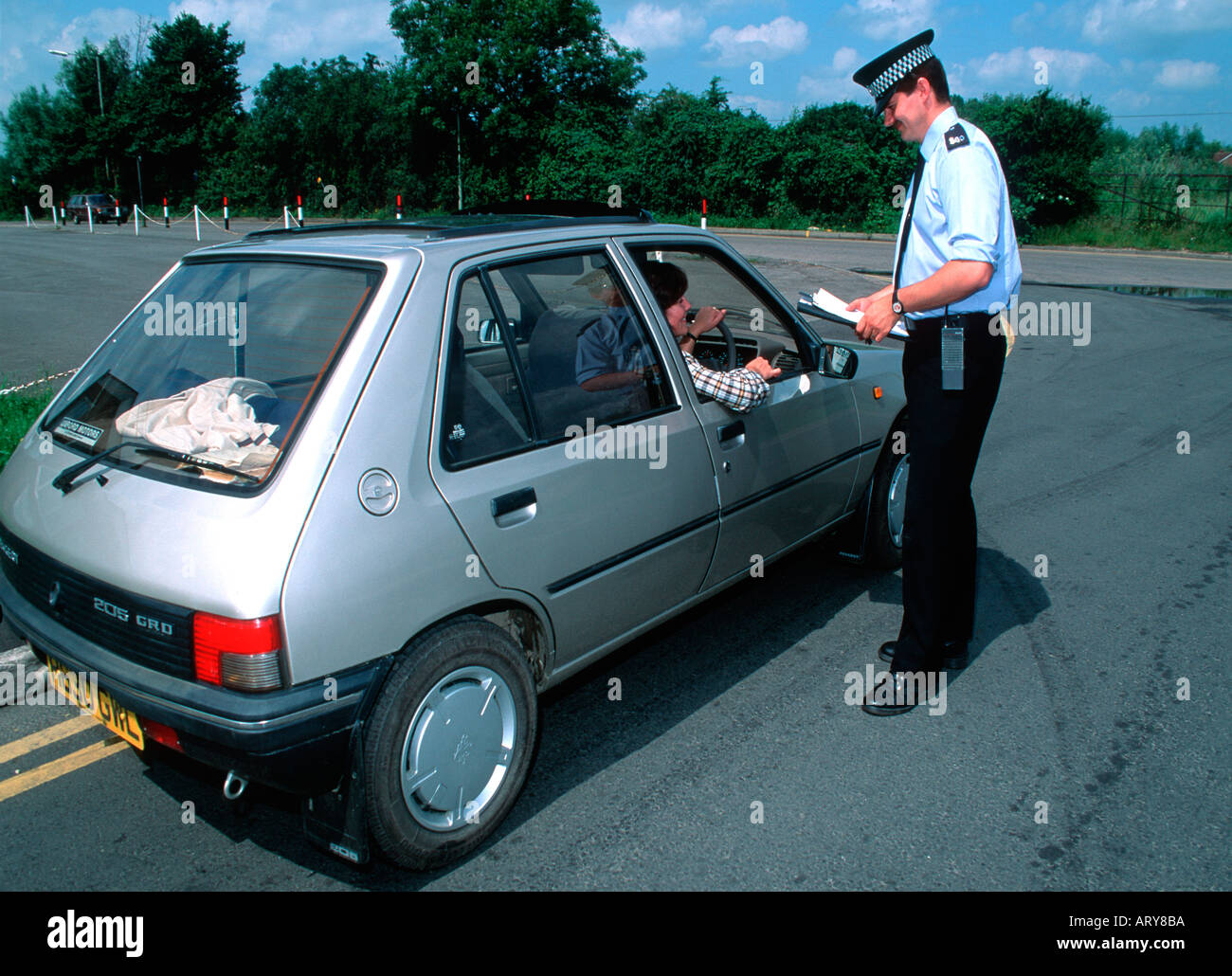 Police constable stops car to check driver for alcohol limits Cotswolds UK Stock Photo