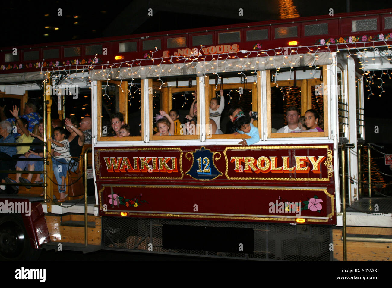 Adorned with Christmas lights, the Waikiki Trolley guides visitors thru  downtown Honolulu to see the giant Christmas Tree in Stock Photo - Alamy