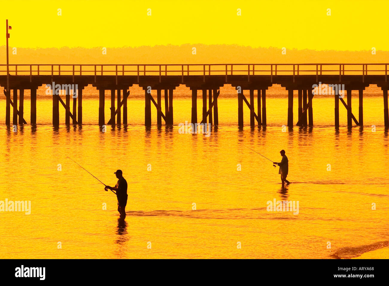 Fishermen at Sunrise Urangan Pier Hervey Bay Fraser Coast Queensland Australia Stock Photo