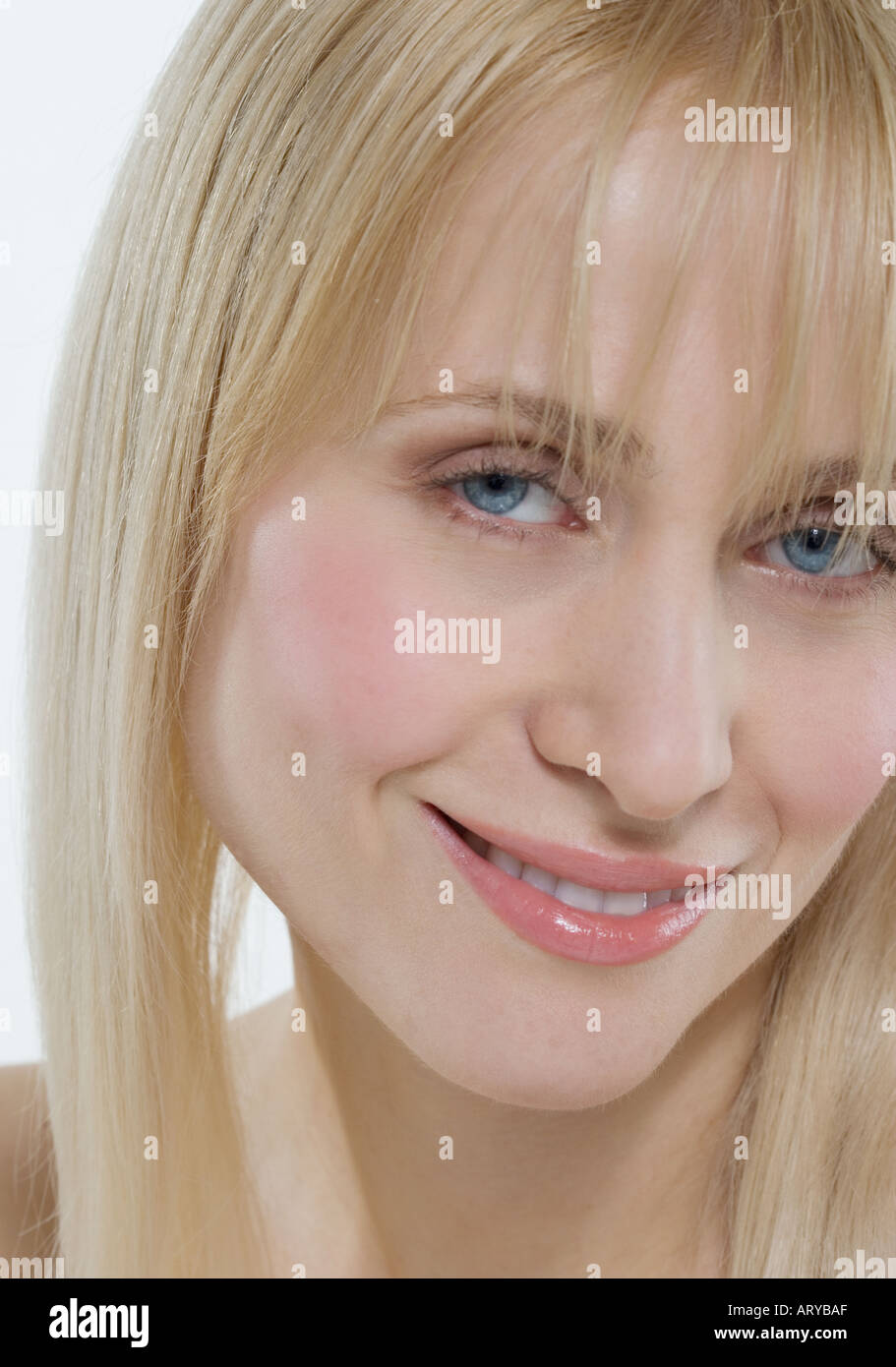 Headshot of woman with coy smile Stock Photo