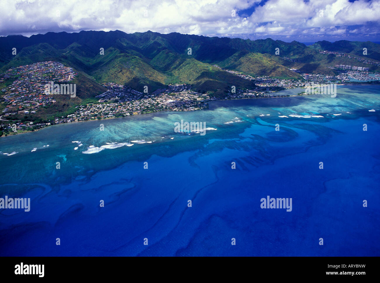Aerial view of east Oahu with homes along the hillside mountains and wide sweeping view of the blue pacific ocean Stock Photo