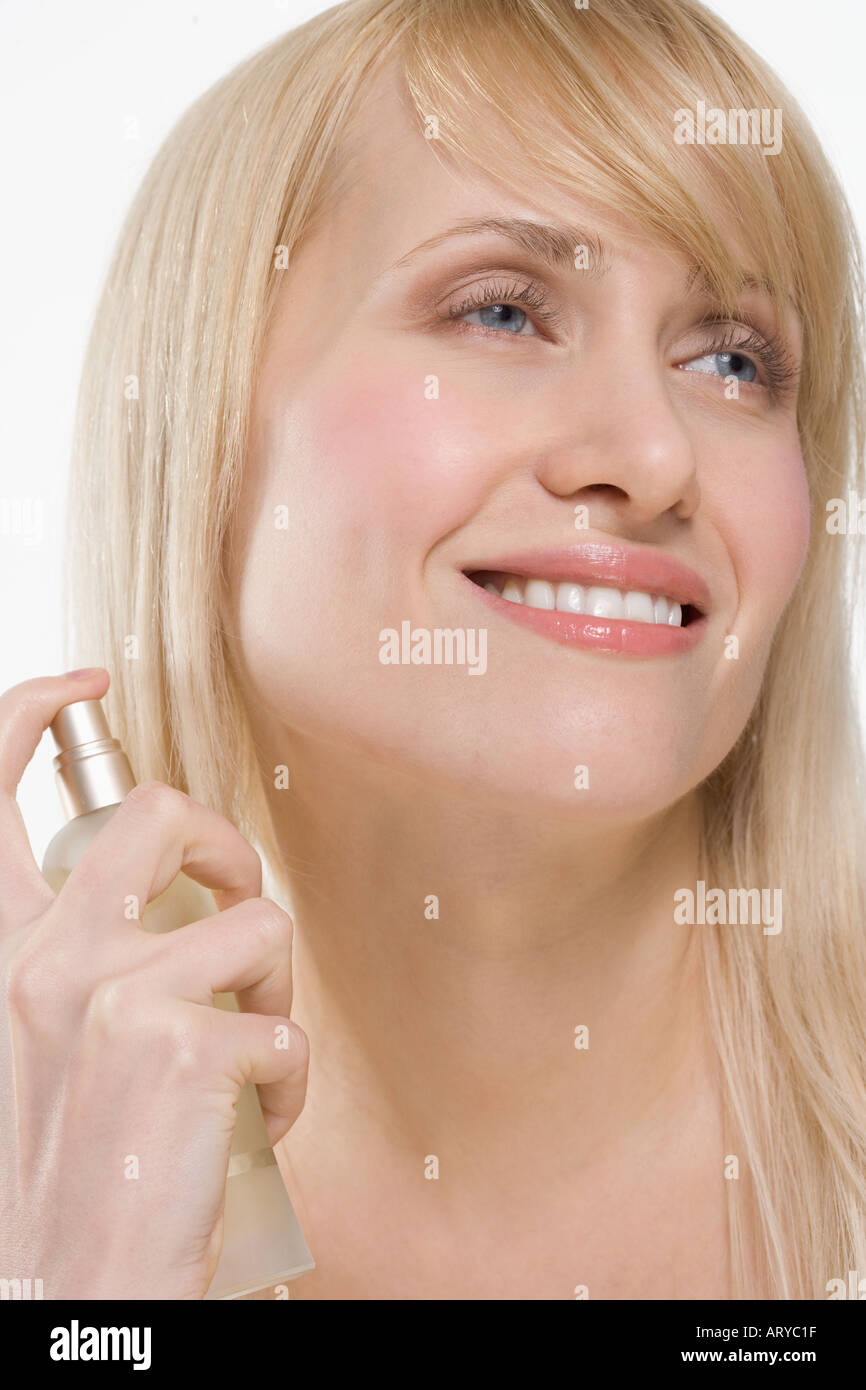 Smiling woman with spray bottle Stock Photo Alamy