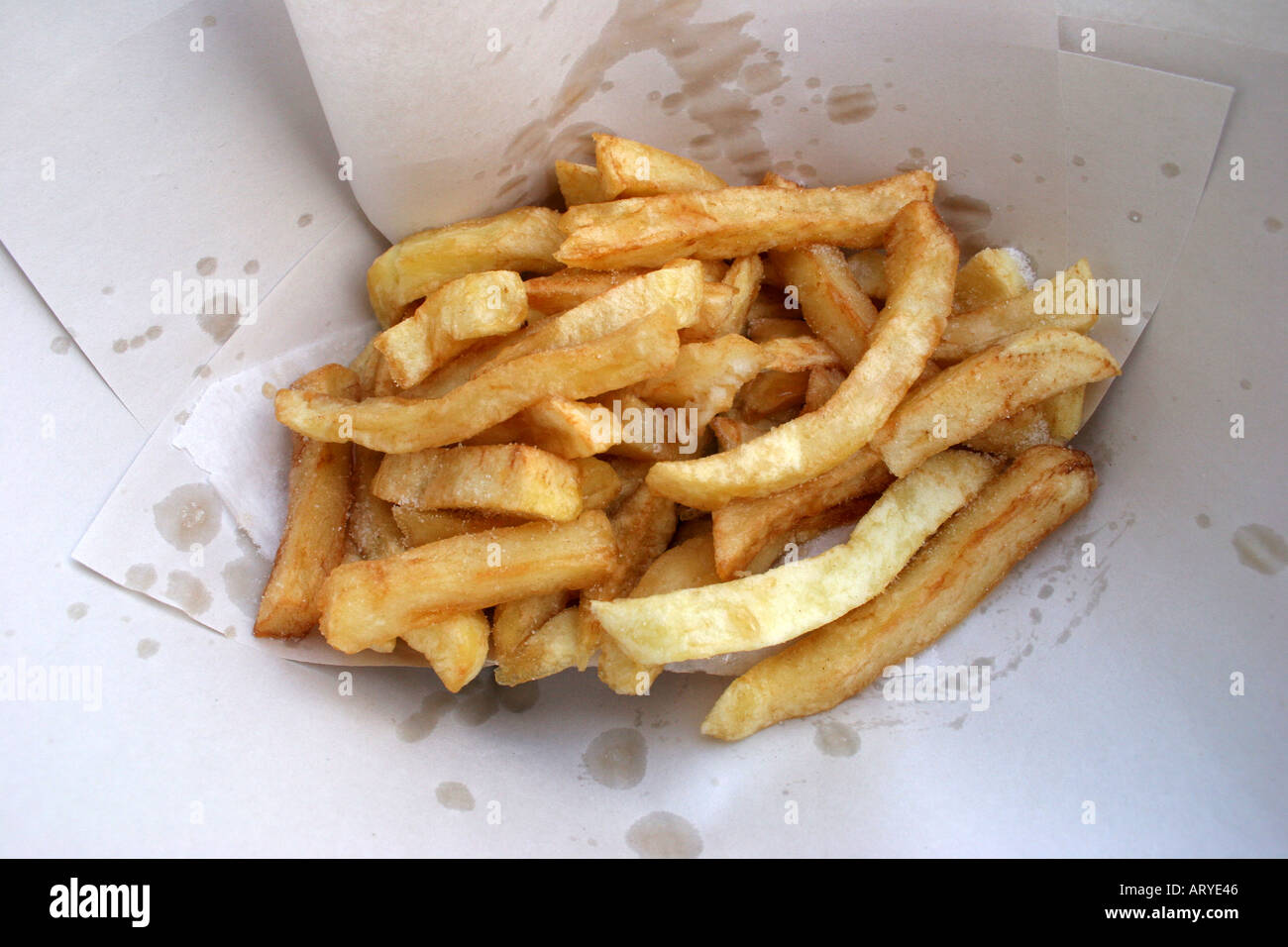 Traditional English chips wrapped in paper studio still life Stock Photo